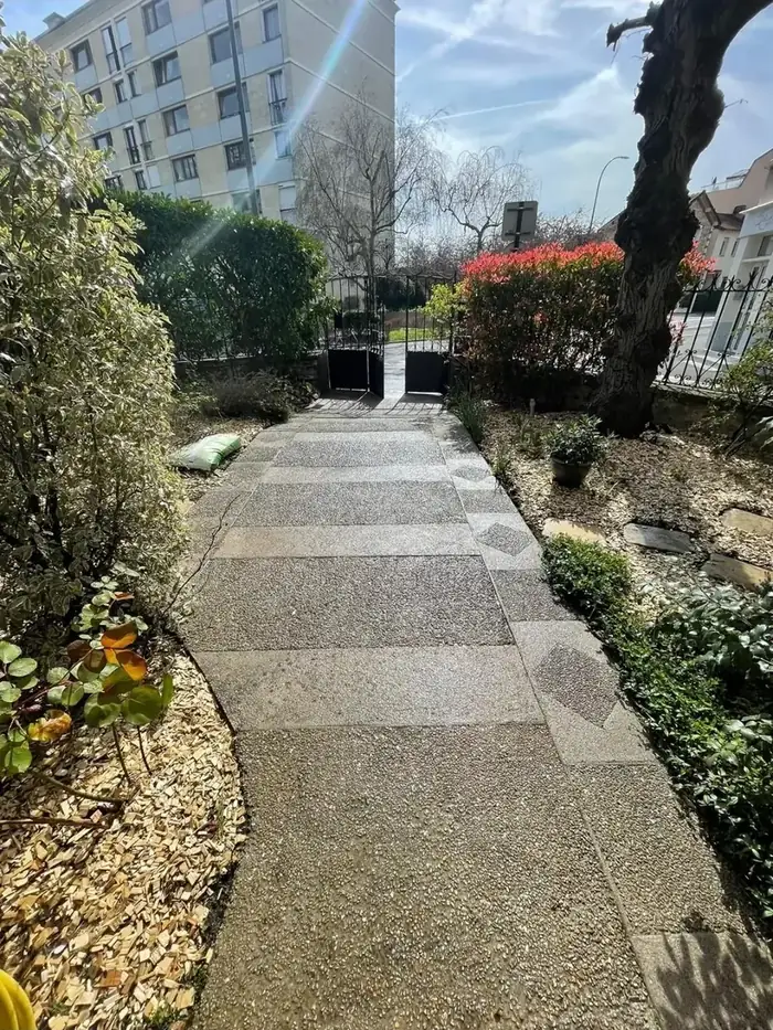 Allée en dalles de grès traversant un jardin